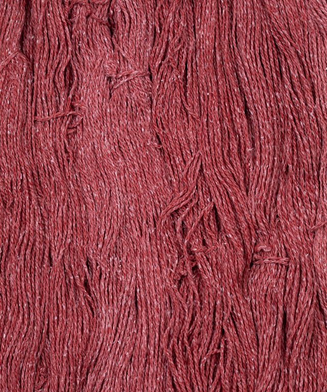 Skeins of deep red Brooklyn Tweed Dapple yarn. 